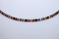 Multicolored beaded necklace on a light gray background