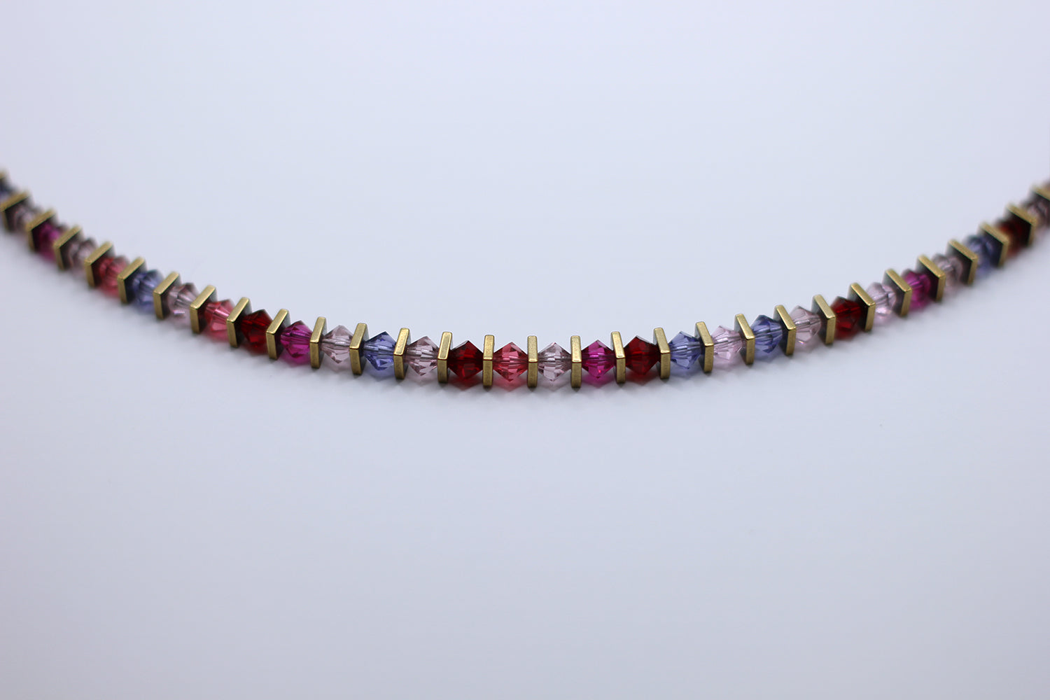Multicolored beaded necklace on a light gray background